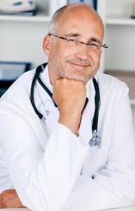 smiling-doctor-with-chin-on-hand-s-710400